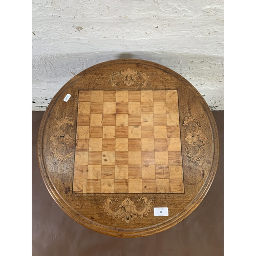 37 - A Victorian inlaid walnut circular tripod games table - approx. 68cm high x 53cm diameter