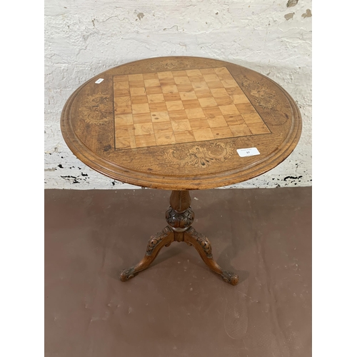 37 - A Victorian inlaid walnut circular tripod games table - approx. 68cm high x 53cm diameter