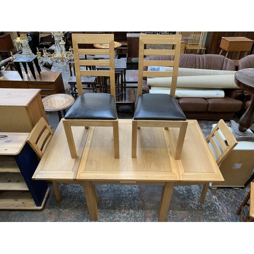 39 - A modern oak rectangular extending dining table and four chairs - approx. 79cm high x 90cm wide x 16... 