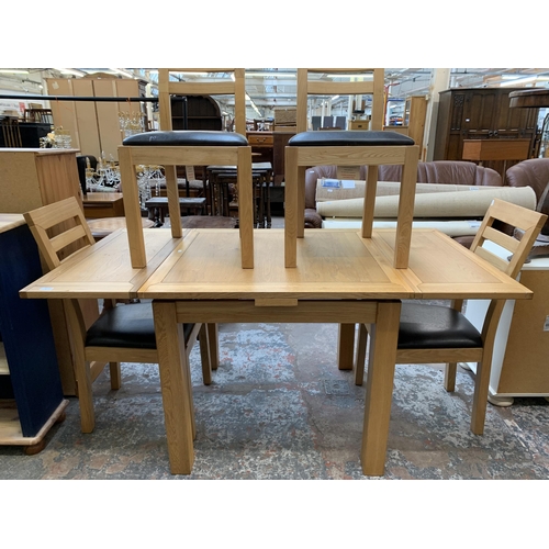 39 - A modern oak rectangular extending dining table and four chairs - approx. 79cm high x 90cm wide x 16... 