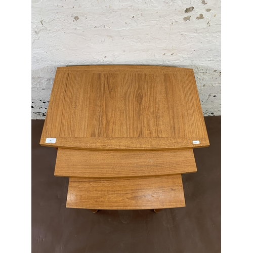 40 - Two pieces of furniture, one oak magazine rack and one mid 20th century teak effect nest of tables