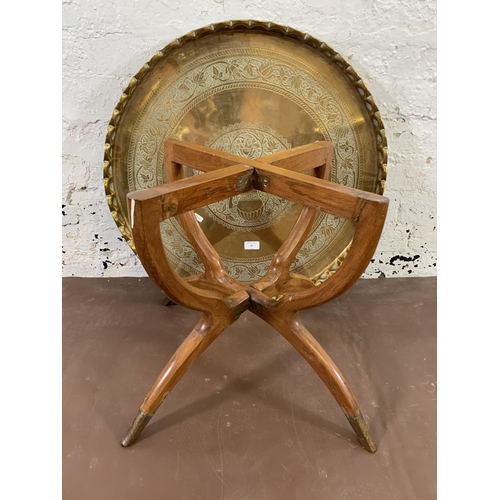 41 - A mid 20th century hardwood folding spider leg travel table with engraved brass circular tray - appr... 