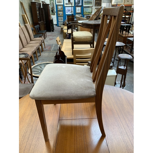 43 - A mid 20th century teak extending dining table and four G Plan teak dining chairs - approx. 71cm hig... 