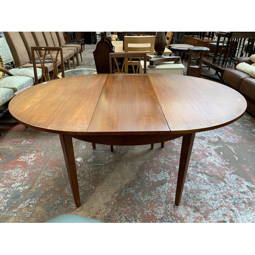 43 - A mid 20th century teak extending dining table and four G Plan teak dining chairs - approx. 71cm hig... 