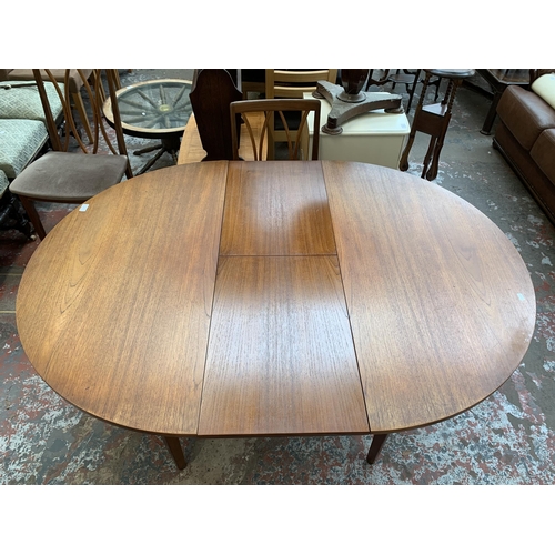 43 - A mid 20th century teak extending dining table and four G Plan teak dining chairs - approx. 71cm hig... 