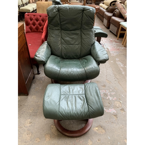 50 - An Ekornes Stressless green leather and bentwood swivel reclining armchair and footstool