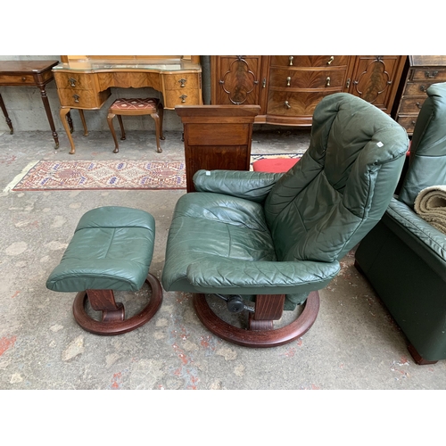 50 - An Ekornes Stressless green leather and bentwood swivel reclining armchair and footstool