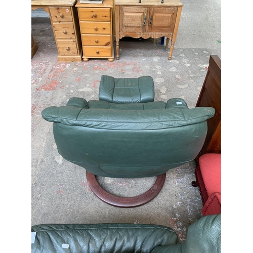 50 - An Ekornes Stressless green leather and bentwood swivel reclining armchair and footstool