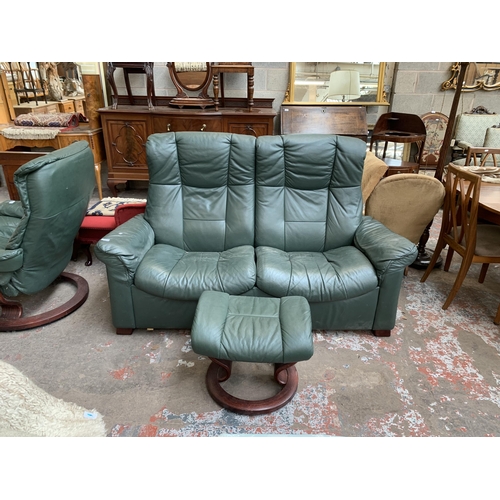 51 - An Ekornes Stressless green leather reclining two seater sofa and footstool