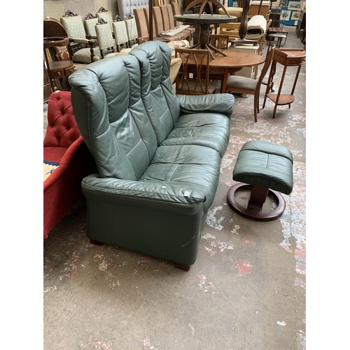 51 - An Ekornes Stressless green leather reclining two seater sofa and footstool