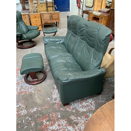 51 - An Ekornes Stressless green leather reclining two seater sofa and footstool