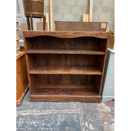 63 - A modern hardwood three tier bookcase - approx. 90cm high x 92cm wide x 29cm deep