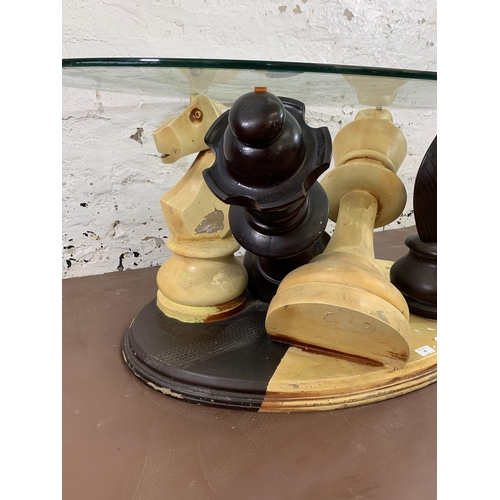 68 - A modern painted fibreglass and bevelled glass top chess piece coffee table - approx. 50cm high x 80... 