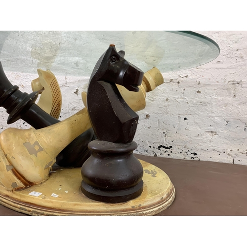 68 - A modern painted fibreglass and bevelled glass top chess piece coffee table - approx. 50cm high x 80... 