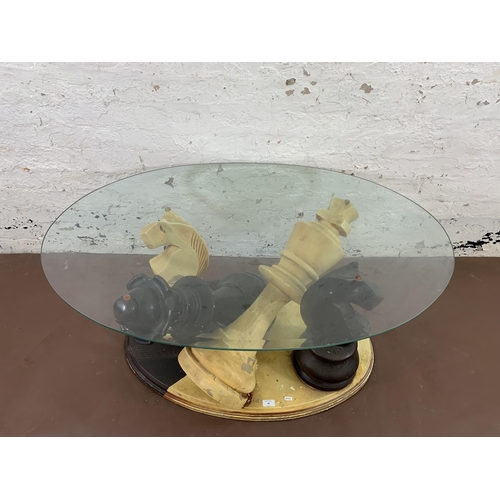 68 - A modern painted fibreglass and bevelled glass top chess piece coffee table - approx. 50cm high x 80... 