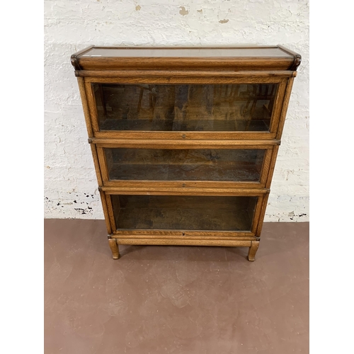 70 - An early 20th century Globe-Wernicke oak three section stacking bookcase - approx. 116cm high x 87cm... 