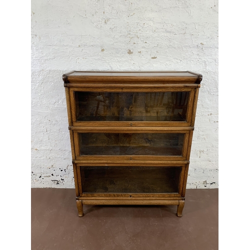 70 - An early 20th century Globe-Wernicke oak three section stacking bookcase - approx. 116cm high x 87cm... 