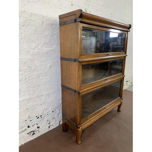 70 - An early 20th century Globe-Wernicke oak three section stacking bookcase - approx. 116cm high x 87cm... 