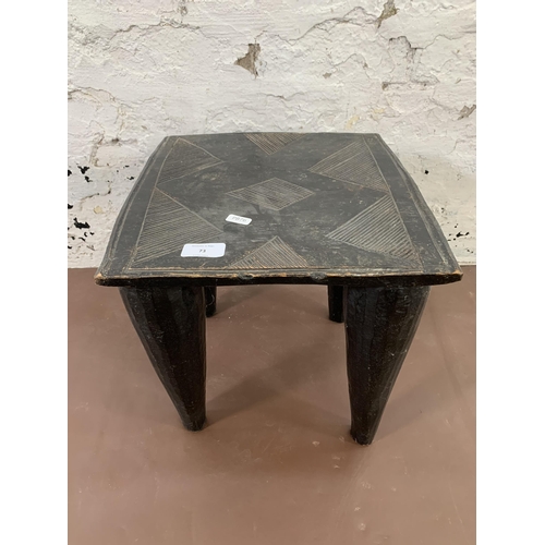 73 - An African ebonised hardwood nupe stool - approx. 32cm high x 32cm wide x 32cm deep