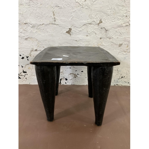 73 - An African ebonised hardwood nupe stool - approx. 32cm high x 32cm wide x 32cm deep