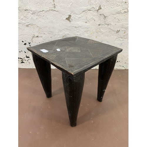 73 - An African ebonised hardwood nupe stool - approx. 32cm high x 32cm wide x 32cm deep