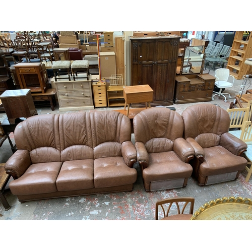 77 - A modern brown leather and stained beech three piece lounge suite comprising three seater sofa and t... 