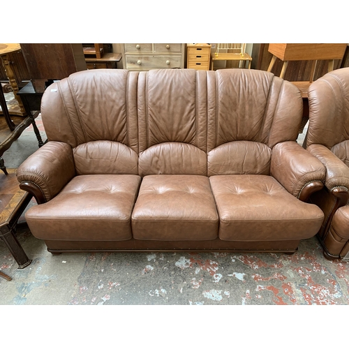 77 - A modern brown leather and stained beech three piece lounge suite comprising three seater sofa and t... 