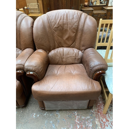 77 - A modern brown leather and stained beech three piece lounge suite comprising three seater sofa and t... 