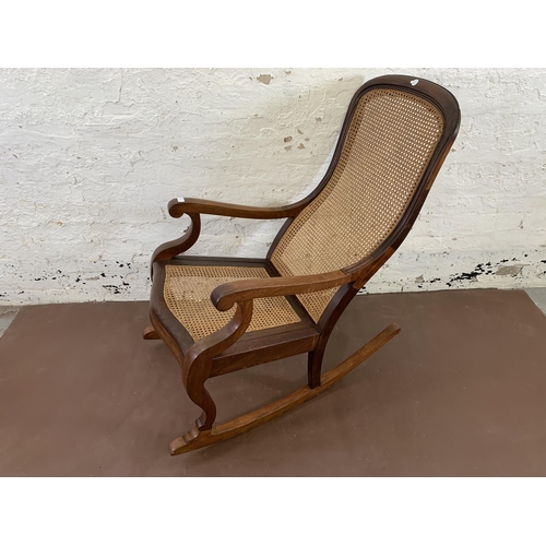 88 - A Victorian mahogany and cane 'Lincoln' rocking chair