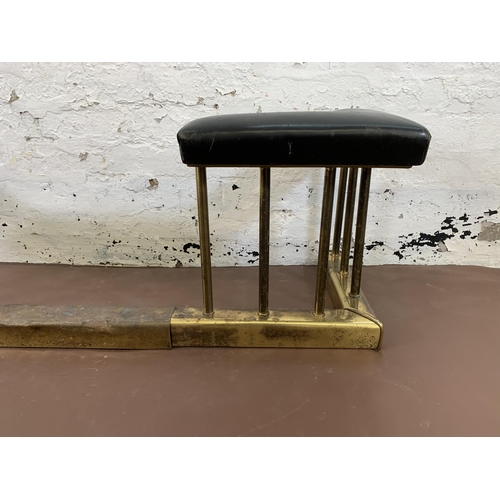 89 - An early 20th century brass and black vinyl upholstered club fender - approx. 43cm high x 142cm wide... 