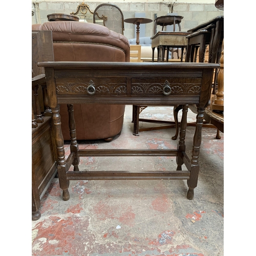 94 - A carved oak two drawer console table - approx. 74cm high x 78cm wide x 32cm deep