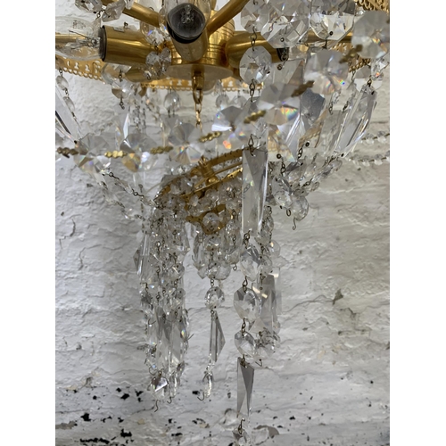 96 - A modern gilt metal and crystal six branch chandelier - approx. 94cm drop x 66cm diameter