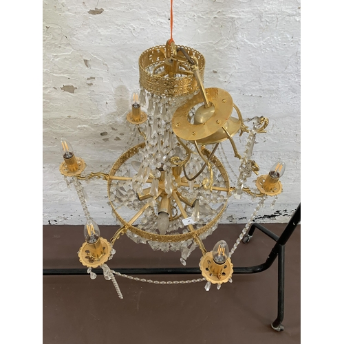 97 - A modern gilt metal and crystal six branch chandelier - approx. 100cm drop x 66cm diameter