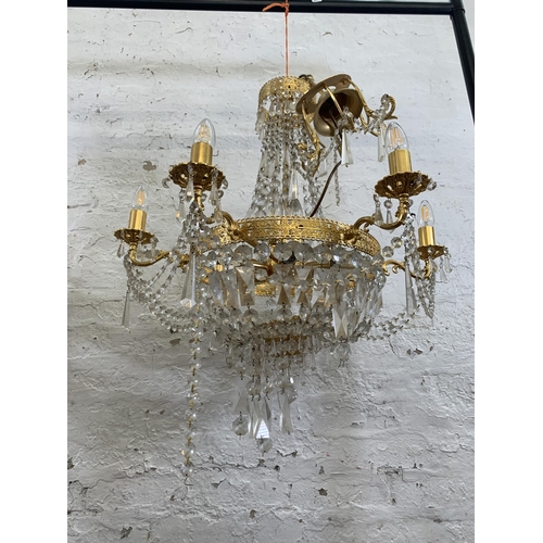 97 - A modern gilt metal and crystal six branch chandelier - approx. 100cm drop x 66cm diameter