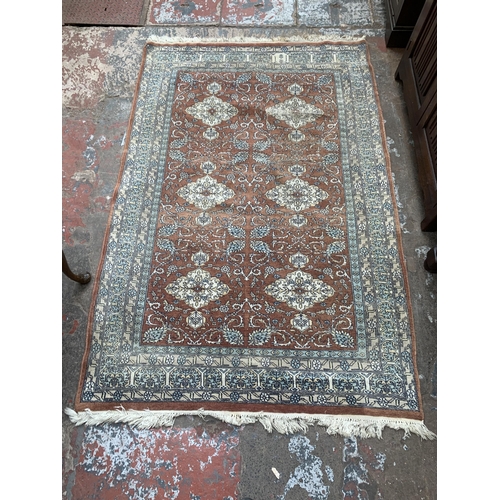 97B - A mid/late 20th century Persian machine woven rug - approx. 190cm x 125cm