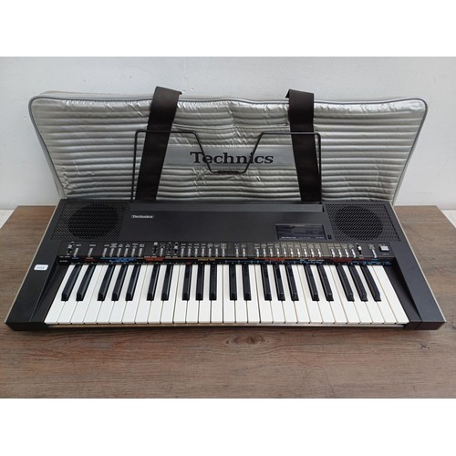A cased Technics SX-K200 electronic keyboard