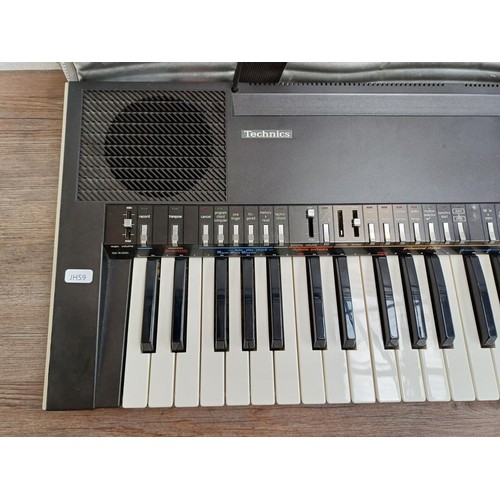 A cased Technics SX-K200 electronic keyboard