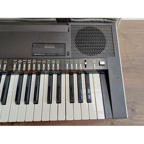A cased Technics SX-K200 electronic keyboard