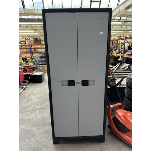 973 - A plastic two door garage storage cabinet - approx. 181cm high x 78cm wide x 43cm deep