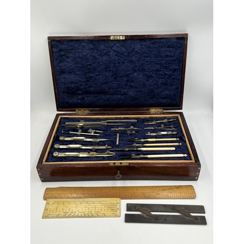 2063 - A late 19th/early 20th century mahogany cased precision drawing set