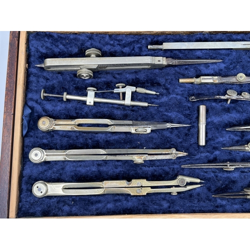 2063 - A late 19th/early 20th century mahogany cased precision drawing set