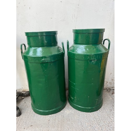 150A - A pair of vintage Co-op Society Ltd green painted galvanised milk churns - approx. 72cm high