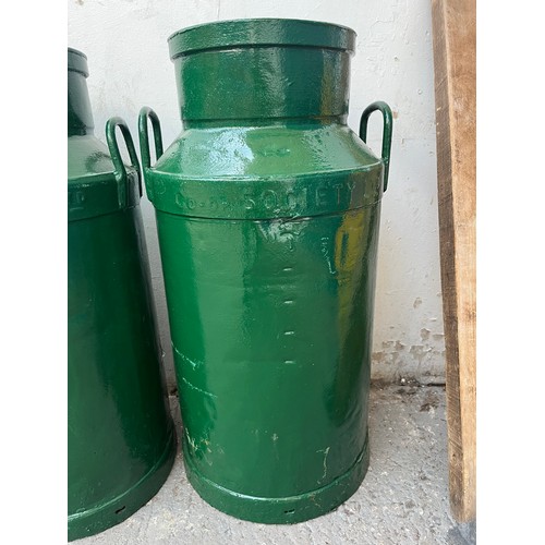 150A - A pair of vintage Co-op Society Ltd green painted galvanised milk churns - approx. 72cm high