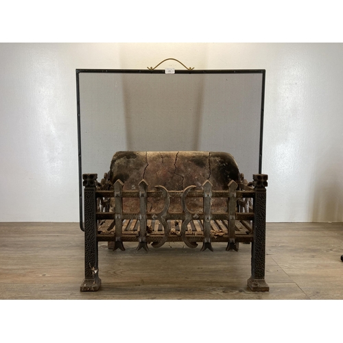 399 - Two fireside accessories, one 19th century cast iron casket shaped grate with firebrick back and one... 