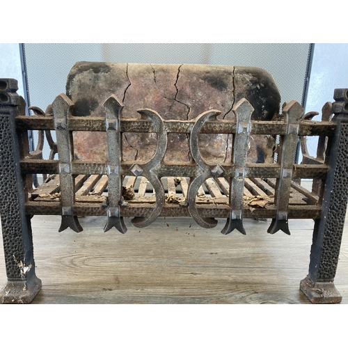 399 - Two fireside accessories, one 19th century cast iron casket shaped grate with firebrick back and one... 