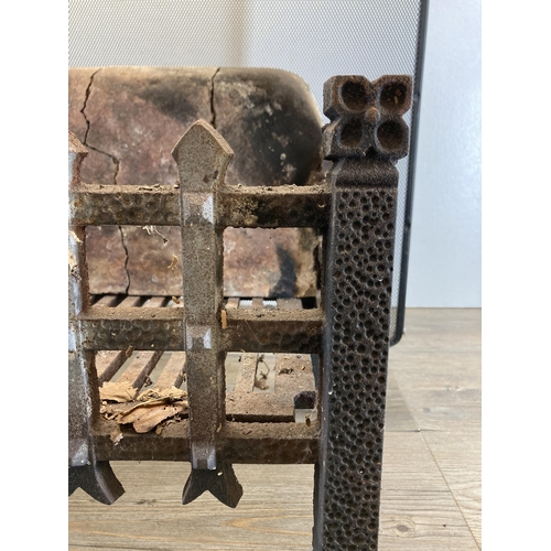 399 - Two fireside accessories, one 19th century cast iron casket shaped grate with firebrick back and one... 