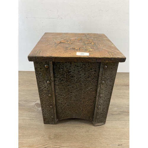 402 - An Arts & Crafts copper on brass coal box with embossed hunting design top - approx. 32cm high x 28.... 