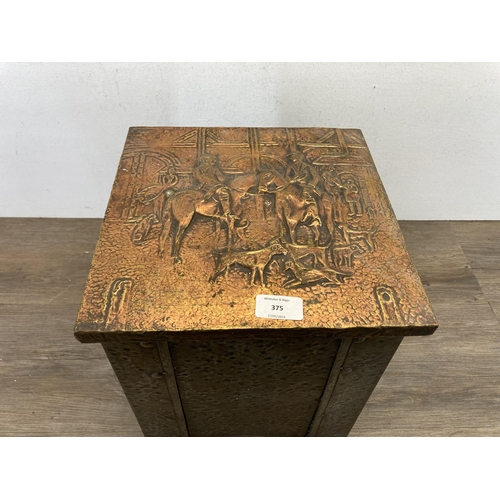 402 - An Arts & Crafts copper on brass coal box with embossed hunting design top - approx. 32cm high x 28.... 