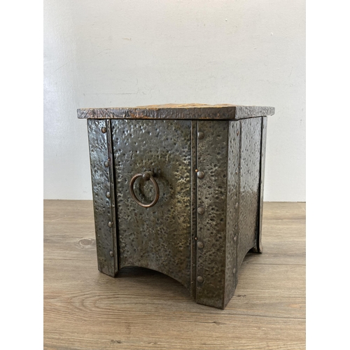 402 - An Arts & Crafts copper on brass coal box with embossed hunting design top - approx. 32cm high x 28.... 