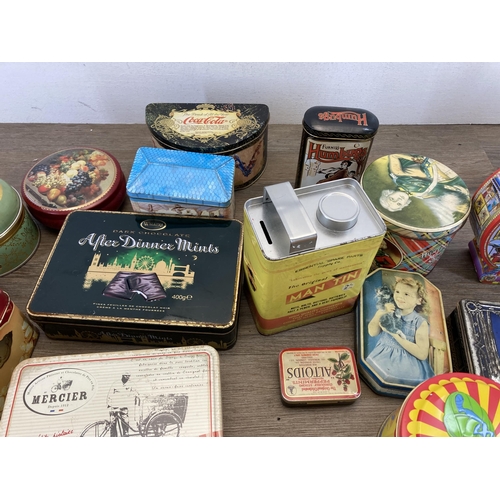 407 - A collection of vintage tins to include Huntley & Palmers, Furniss Humbugs etc.